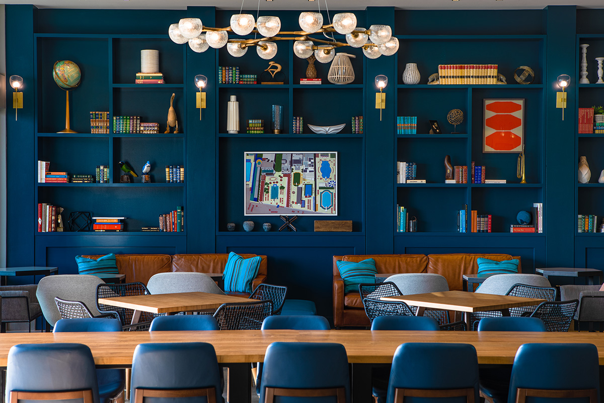 photo of the navy blue bookshelf and lounge area